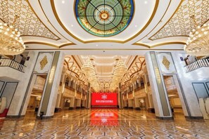 A spacious hotel lobby with a grand chandelier, a central stained glass window, and a red sign on the wall. - Fuqing Yonghong Hotspring Resort (Fuqing)