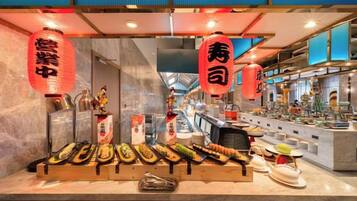 A sushi bar with a variety of dishes displayed on the counter.