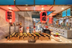 A sushi bar with a variety of dishes displayed on the counter. - Fuqing Yonghong Hotspring Resort (Fuqing)