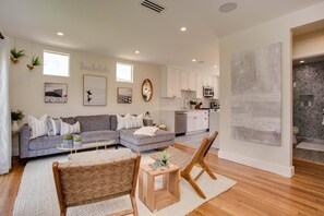 Relax in a cozy seating area with a sectional sofa, coffee table, and woven chairs.