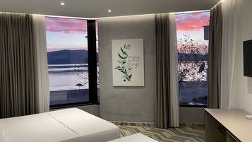 Deluxe Triple Room, Sea View | 1 bedroom, premium bedding, minibar, desk
