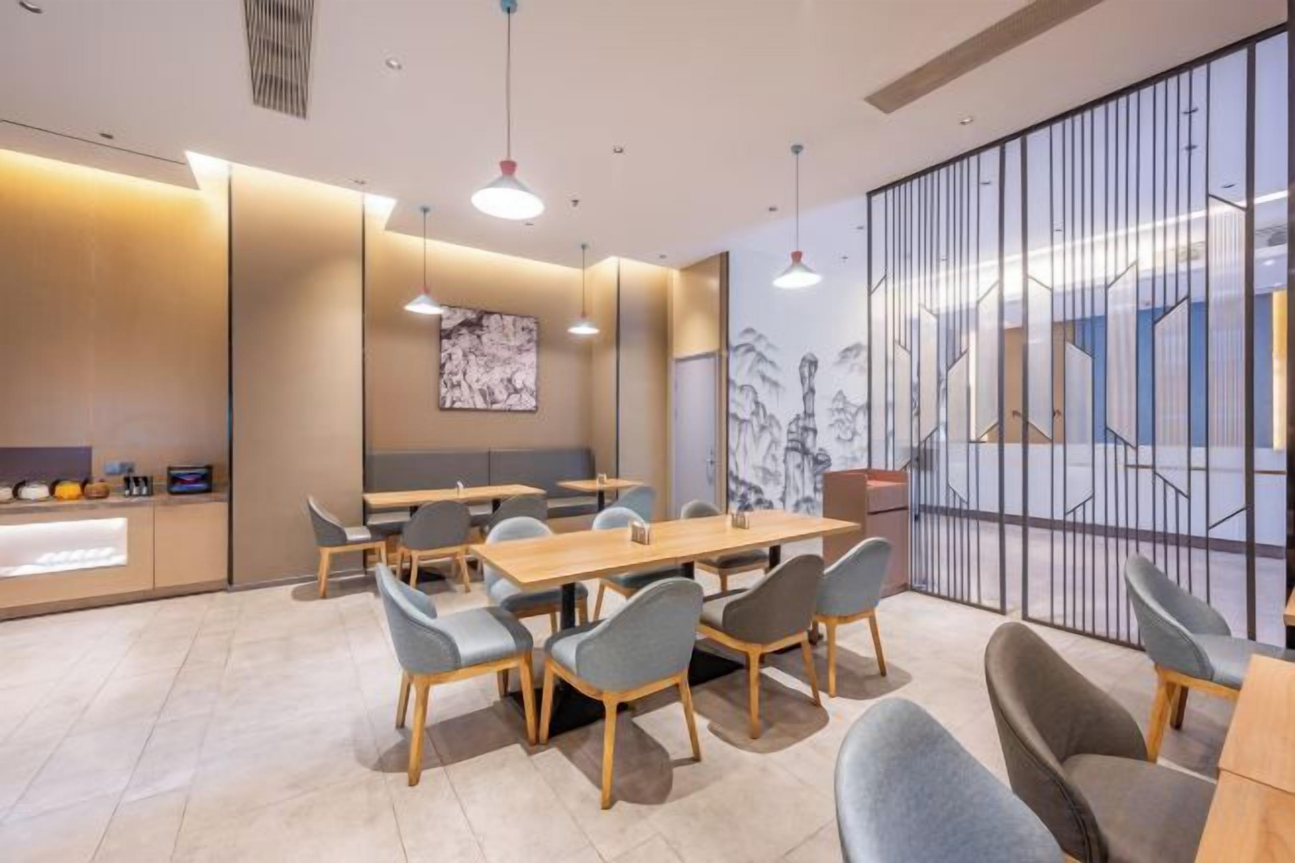 A modern conference room with a long table, chairs, and a partition wall with a geometric design.