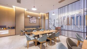 A modern conference room with a long table, chairs, and a partition wall with a geometric design.