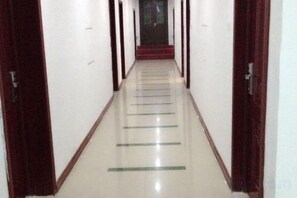 A corridor with doors on both sides, leading to a staircase. - Taining Ping an Express Hotel (Taining)