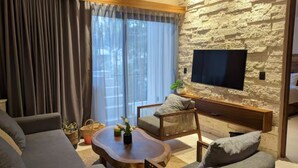 Appartement Élite | Coin séjour | Télévision LED de 40 pouces avec chaînes par câble, télévision