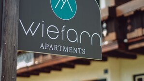 A sign for Wiefarm Apartments with a logo and name. - Apartment Wallberg (Wiefarn Apartments) (Bad Wiessee)