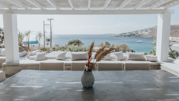 A covered outdoor seating area with a view of the sea. - MyMykonos Villa II Beach Front  (Mykonos)