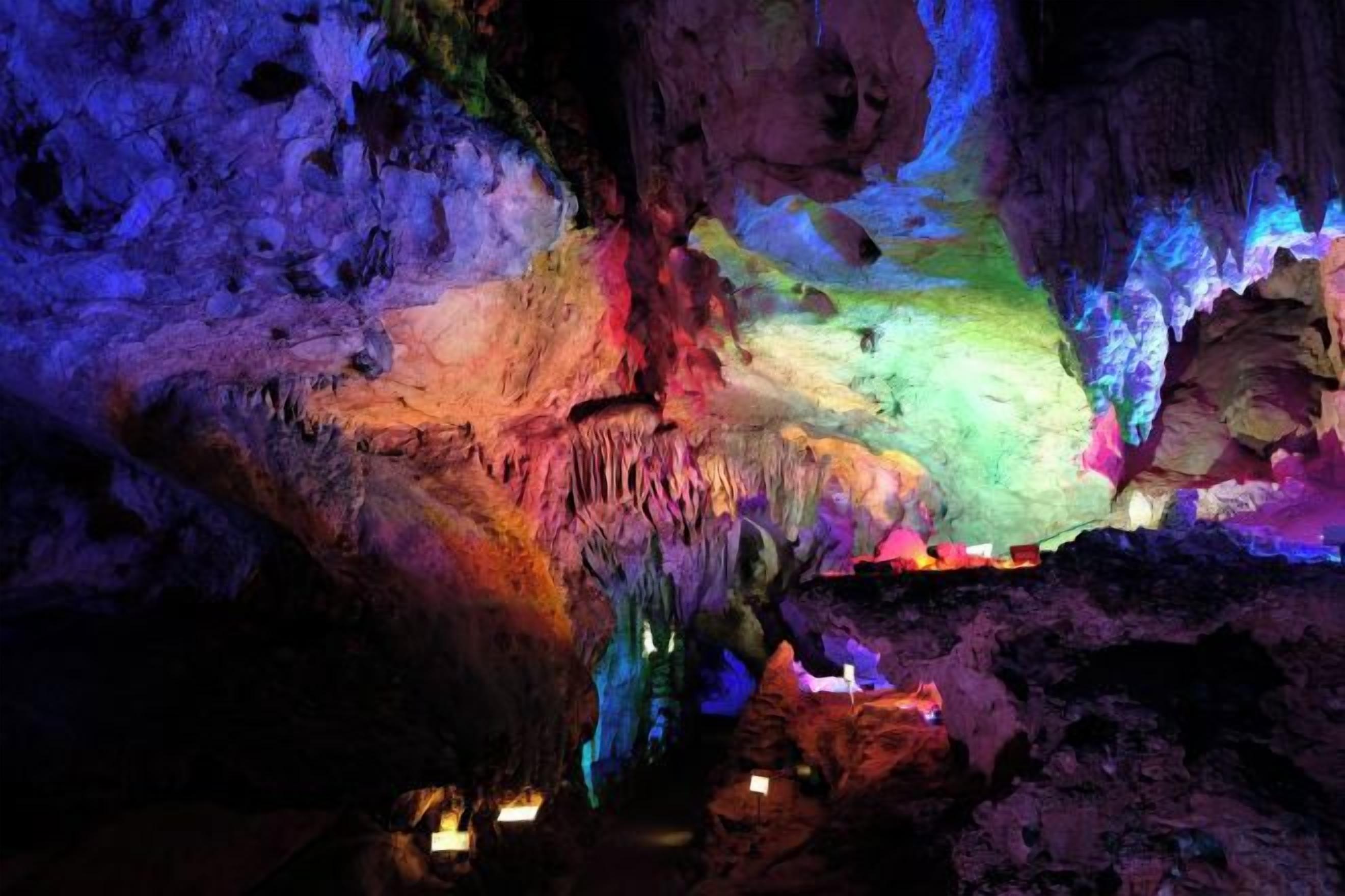 A cave with stalactites and a variety of colors.