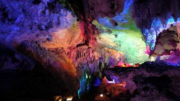 A cave with stalactites and a variety of colors.