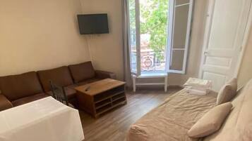 Family Quadruple Room | Living area | 80-cm LED TV with cable channels, TV