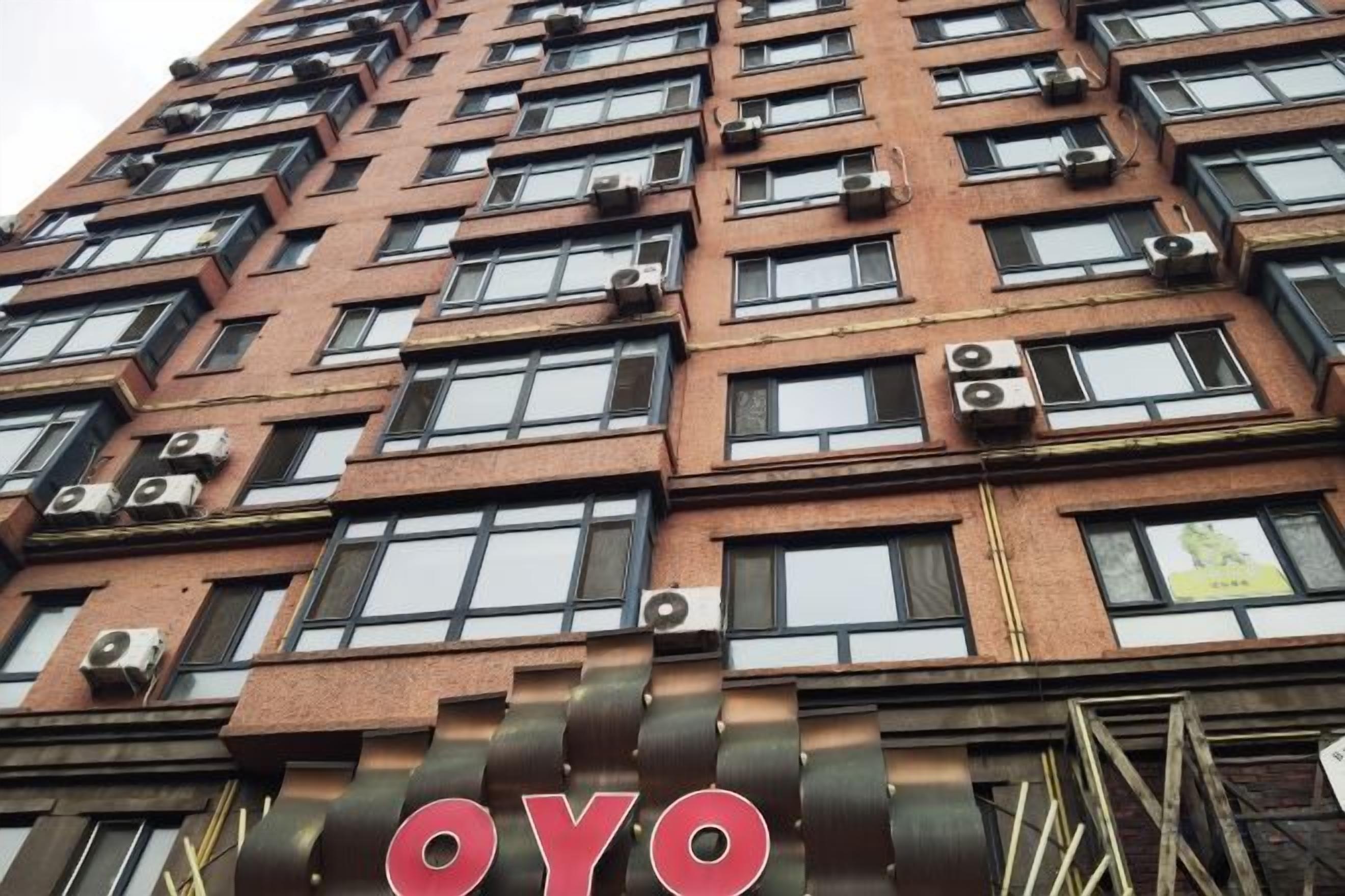 A multi-story building with a prominent 'OYO' sign at the ground level.