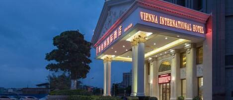 The Vienna International Hotel with classical architecture, including columns and a grand entrance.