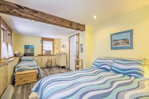 A bedroom with two beds, a wooden desk, and a window with curtains. - Cozy Waterfront Cottage on Montsweag Bay! (Westport)