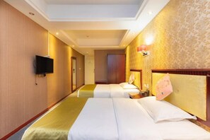 A hotel room with two beds, a television, and a patterned wall.