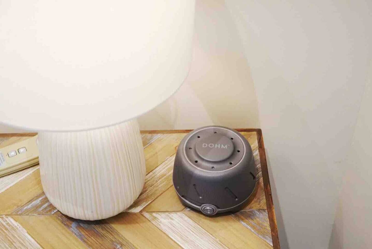 A DOHM device and a lamp on a wooden surface.