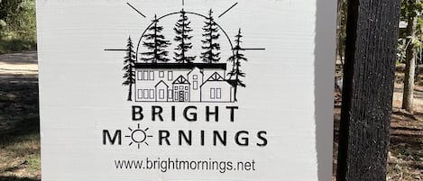 A signboard with the text "BRIGHT MORNINGS" and a website URL.