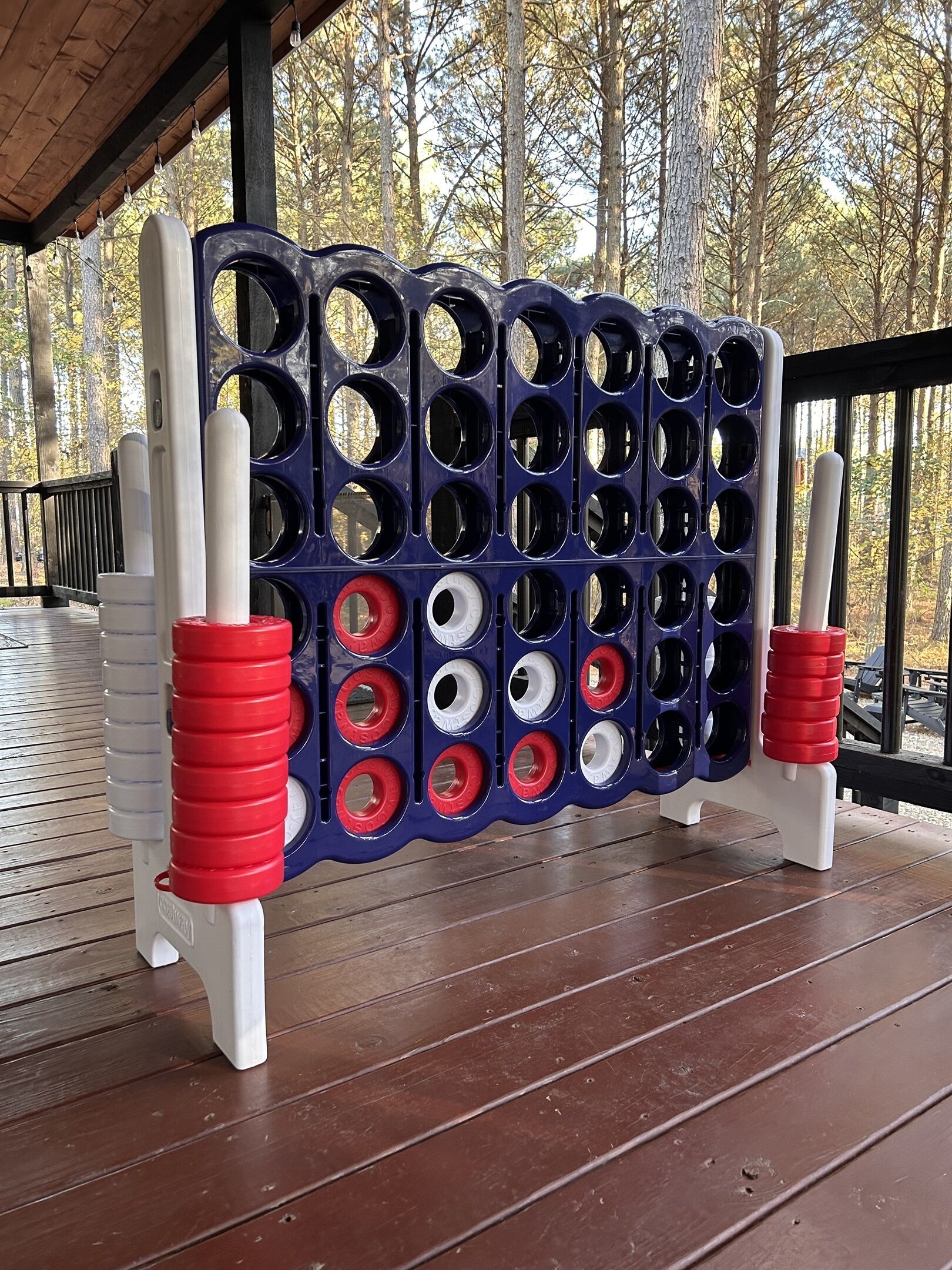 A wooden deck with a blue and white board game setup.