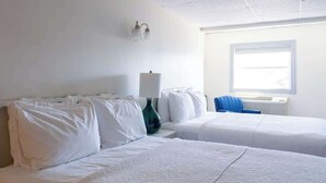 A hotel room with two beds, a lamp, a chair, and a window. - Entire Inn Block & restaurant! (Middletown)
