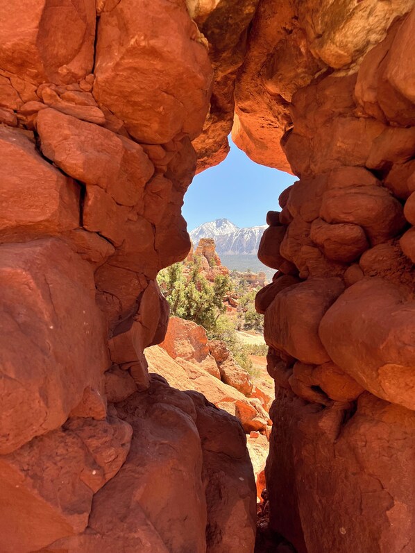 A natural rock formation with a clear view of distant mountains and sparse vegetation. - Charming 3 bedroom Ranch in scenic McElmo Canyon (Cortez)