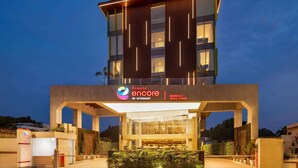 A modern building with a prominent entrance and a sign for Ramada Encore by Wyndham. - Ramada Encore By Wyndham Bareilly Civil Lines (Bareilly)
