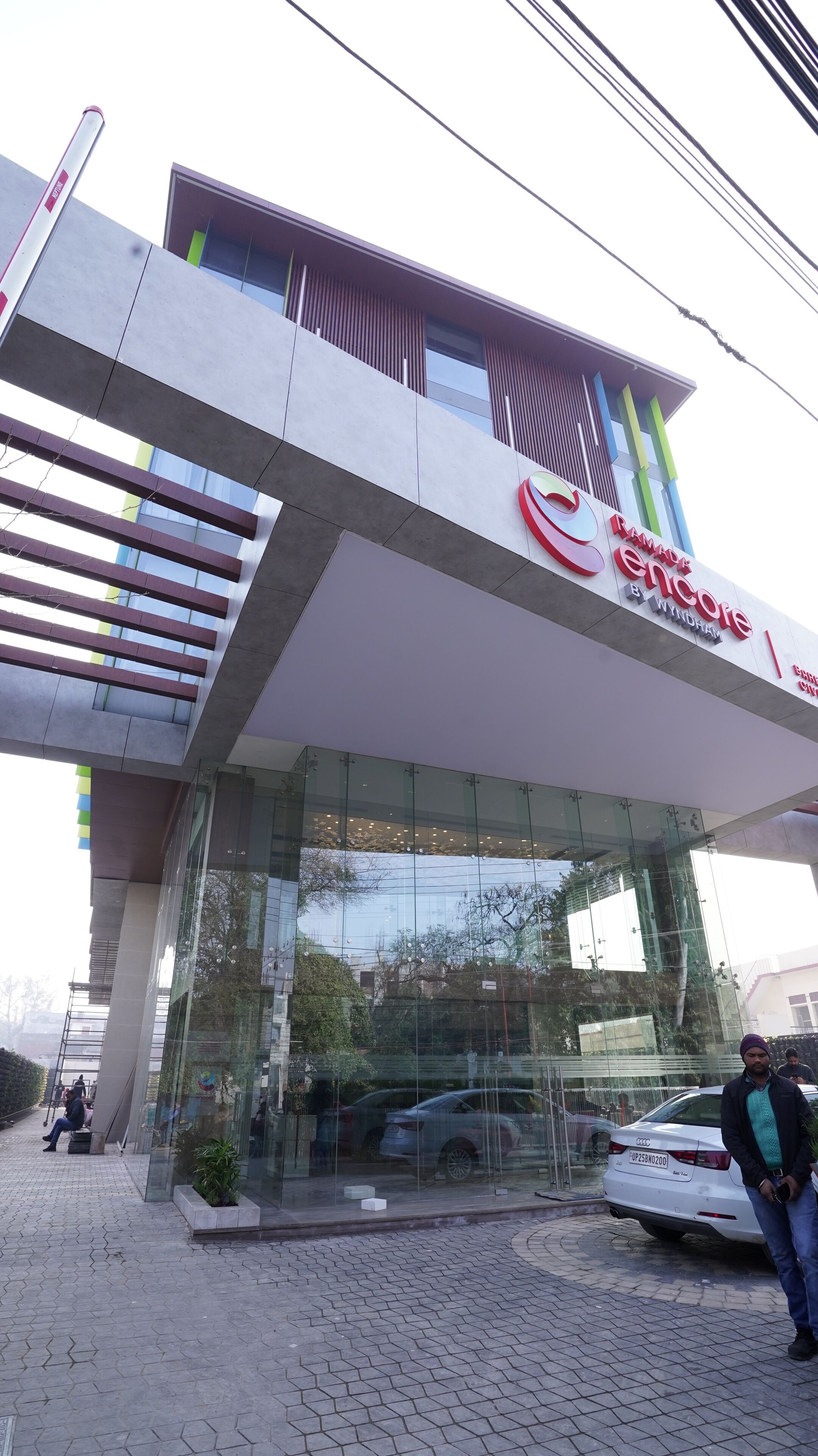 A modern building with a glass facade and a prominent sign reading "Canada Inn".