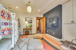 A modern interior with a wooden ceiling, a globe on a table, and a television mounted on the wall. - 'Whistle Pig' A Downtown Escape in Breckenridge (Breckenridge)