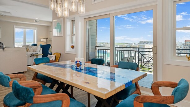A dining area with a large table, chairs, and a view of the city. - Penthouse in Wildwood Crest- Best Views! (Wildwood)