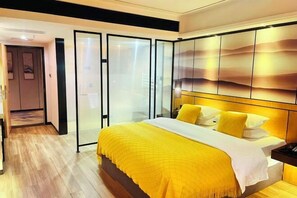 A modern bedroom with a bed, a bedside table, and a sliding glass door leading to a bathroom. - Rong'an International Hotel (Rong'an)