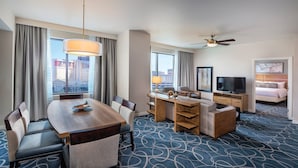 A hotel room with a dining area, a TV, a bed, and a city view. - 1BD/Vegas - Full Kitchen, Washer/Dryer, and Private Living Room! (Las Vegas)