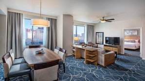 A hotel room with a dining area, a TV, a bed, and a city view. - 1BD/Vegas - Full Kitchen, Washer/Dryer, and Private Living Room! (Las Vegas)
