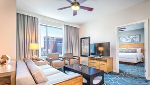 A hotel room with a sofa, chairs, a TV, a desk, and a bed. - 1BD/Vegas - Full Kitchen, Washer/Dryer, and Private Living Room! (Las Vegas)