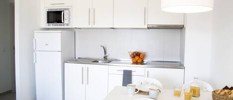 Fridge, coffee/tea maker, cookware/dishes/utensils