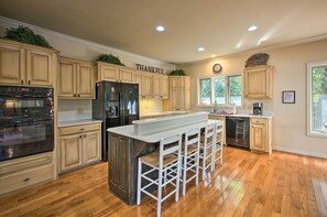 Enjoy cooking in this well-equipped kitchen with a central island and bar stools.