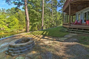 Relax on the deck with a fire pit, surrounded by lush greenery.