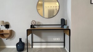 A modern desk with a round mirror, a globe, and a speaker. - Loft with wallbox, WLAN workstation, garage, for 3 people, 100 m to the Moselle (Traben-Trarbach)