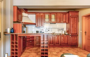Kitchen with oven, sink, and various appliances.