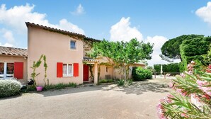A two-story building with a beige facade, red shutters, and a tiled roof. There is a gravel driveway in front, and a tree with green foliage to the right. - Stunning home in Eyragues (Eyragues)