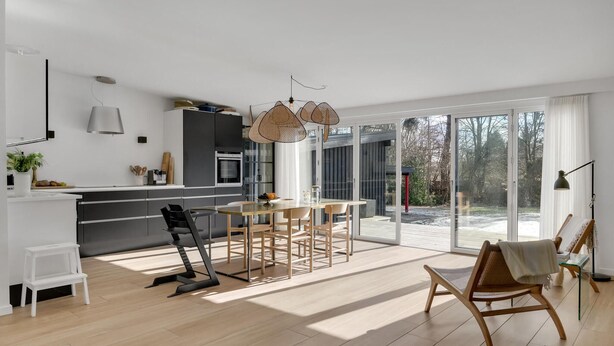A modern kitchen with a dining area, large windows, and a view of the outdoors. - Stunning home in Gilleleje with kitchen (Gilleleje)