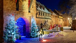A historic building with a stone facade, a large arched entrance, and traditional timber framing. - Refuge of the Imp*** - Romantic Studio for 2 (Riquewihr)