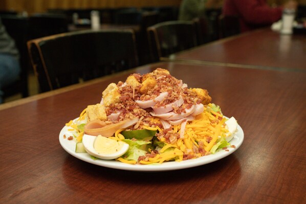 A plate of food on a wooden table. - Bells Marina & Resort (Eutawville)