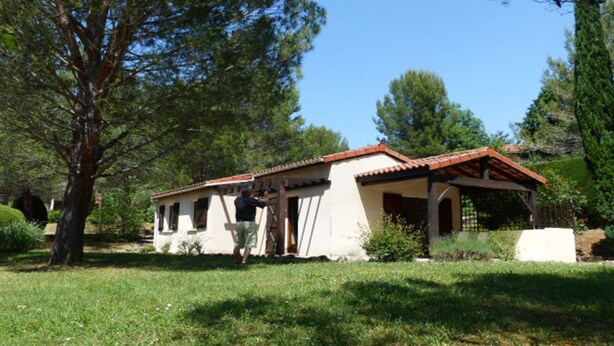A two-story building with a tiled roof, surrounded by trees and grass. - Domaine de l'Espinet Villa Speranza (Quillan)