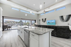 Enjoy cooking in this well-equipped kitchen with a central island, ample counter space, and integrated appliances.