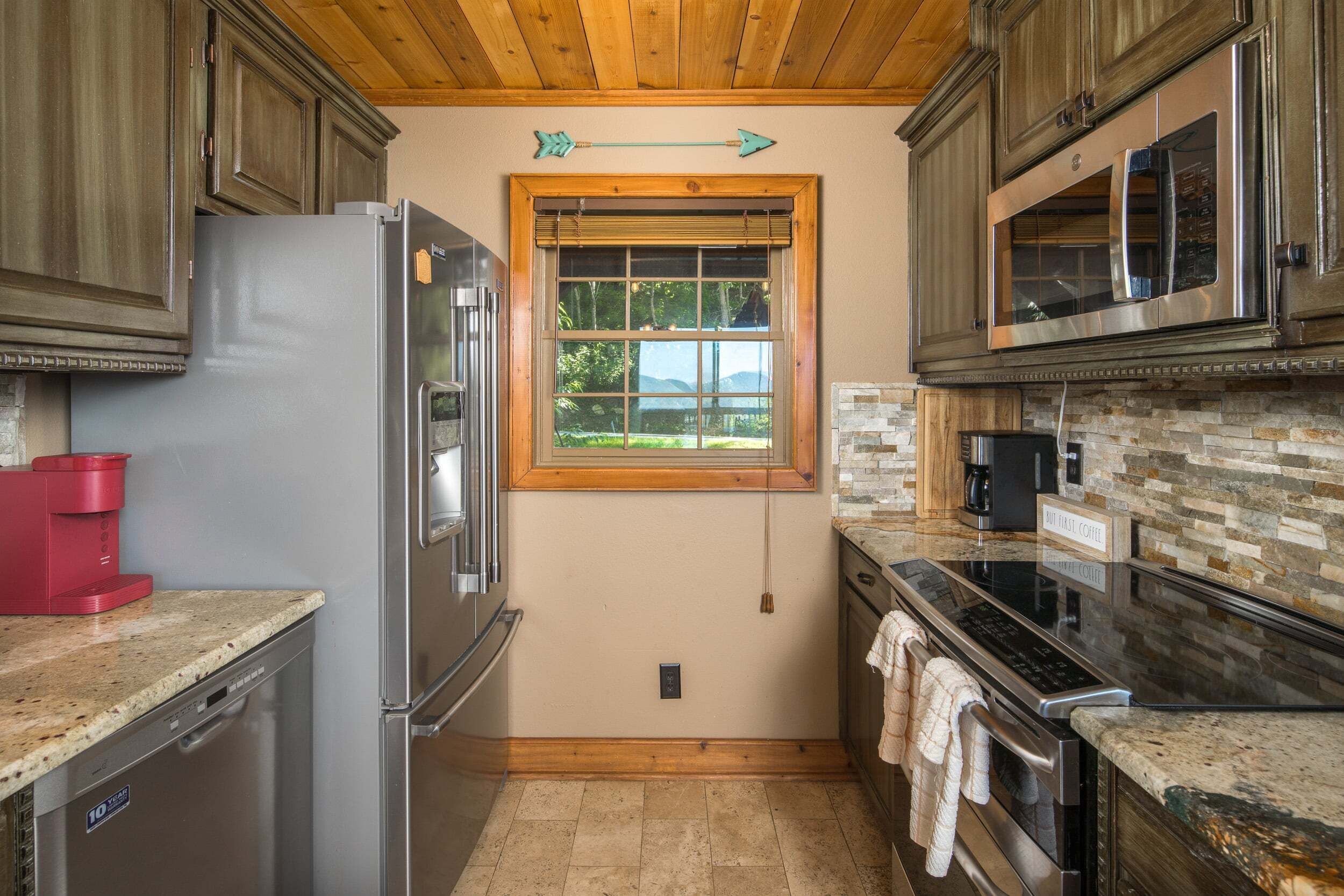A compact kitchen with a refrigerator, microwave, and coffee maker.