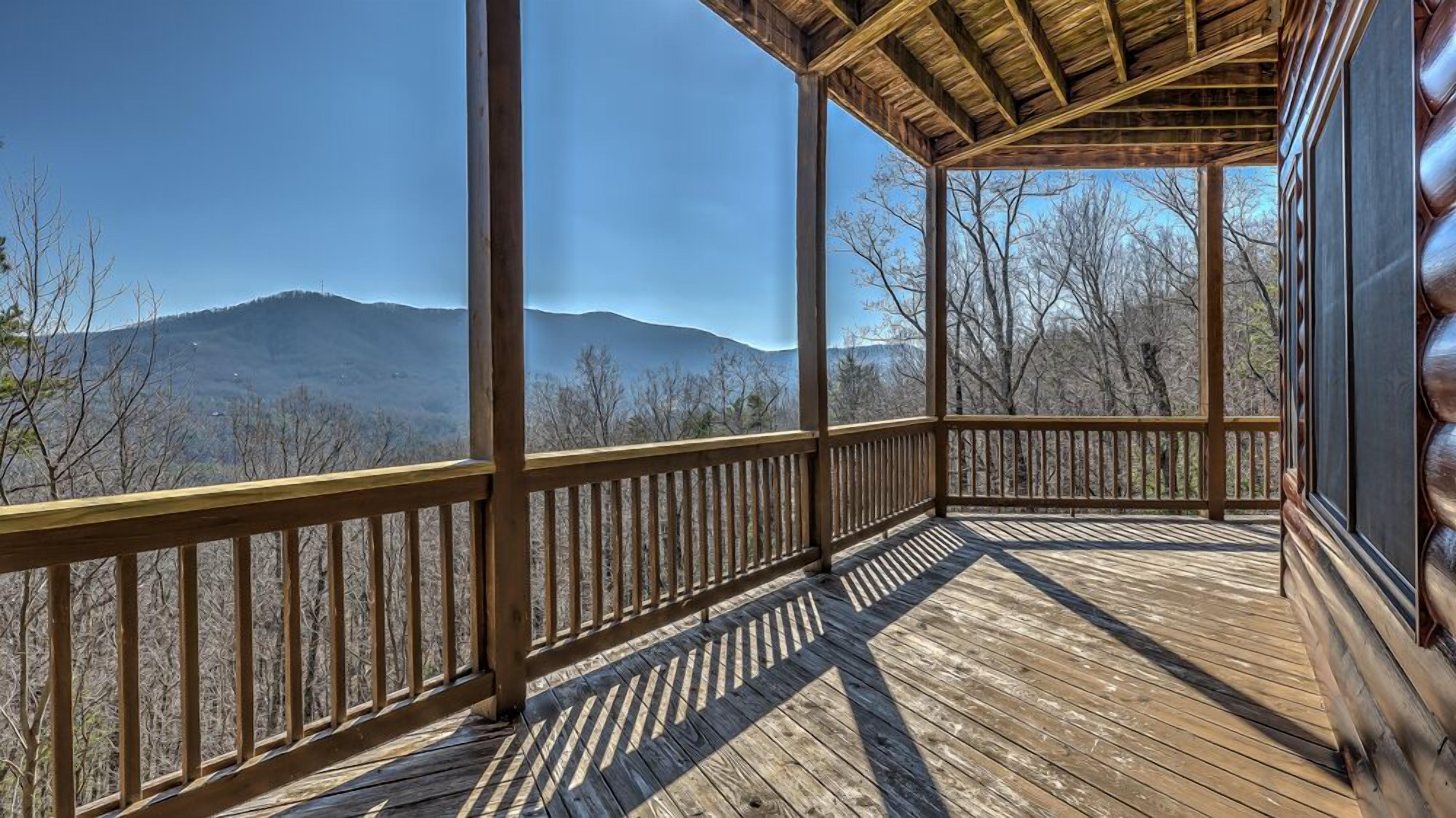 Une terrasse en bois offrant une vue sur les montagnes.