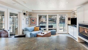 A spacious living area with a fireplace, a sofa, and a coffee table. - Riverfront Cottage - Steam Room & Pet Friendly! (Bend)