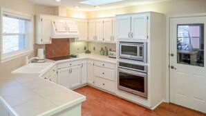 A kitchen with white cabinets, a double oven, and a skylight. - All the Comforts of Home and a View of Lake DeSoto (Hot Springs Village)