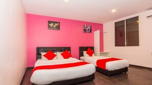 A hotel room with two beds, pink walls, and wooden flooring. - Taj Grand Hotel (Malacca City)