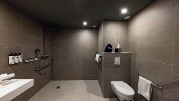 Une salle de bain moderne équipée d’une douche, de toilettes et d’un lavabo.