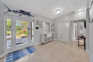 Enjoy the serene atmosphere and beautiful garden views from this stylish room, featuring a decorative fish sculpture and a spacious layout.