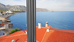 A coastal view with a red-tiled roof, a clear blue sea, and a mountainous backdrop. - Garza Playa - Altea, Costa Blanca (Altea)